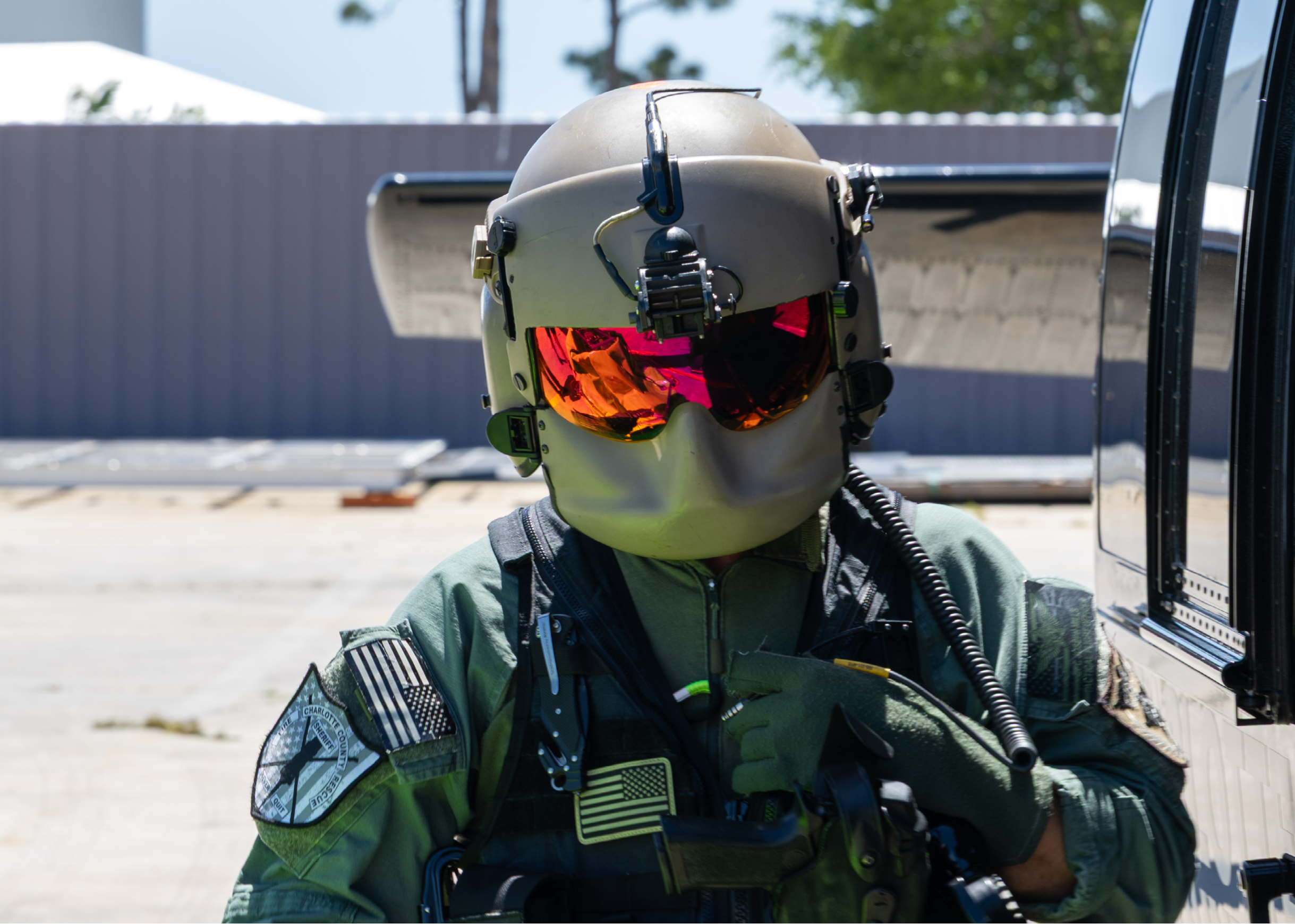 A man wearing a green helmet and goggles. Description generated by AI