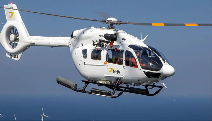 A white helicopter with a yellow and black tail. Description generated by AI