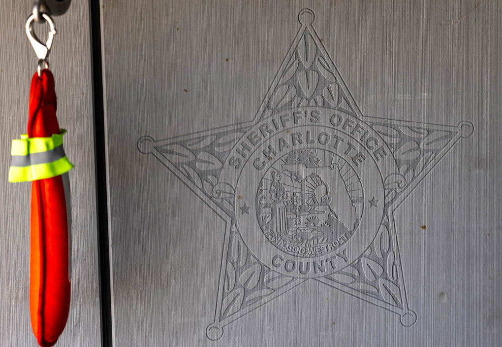 A sheriff's office logo is on a metal surface. Description generated by AI