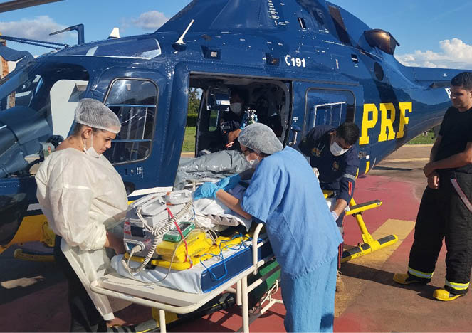 A group of people are working on a patient on a helicopter. Description generated by AI