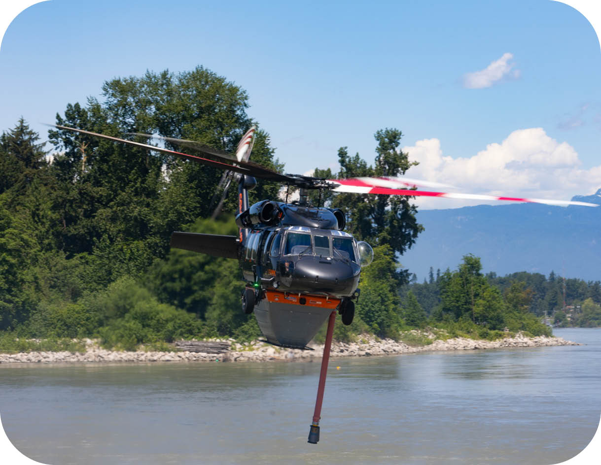 A helicopter is flying over a body of water. Description generated by AI