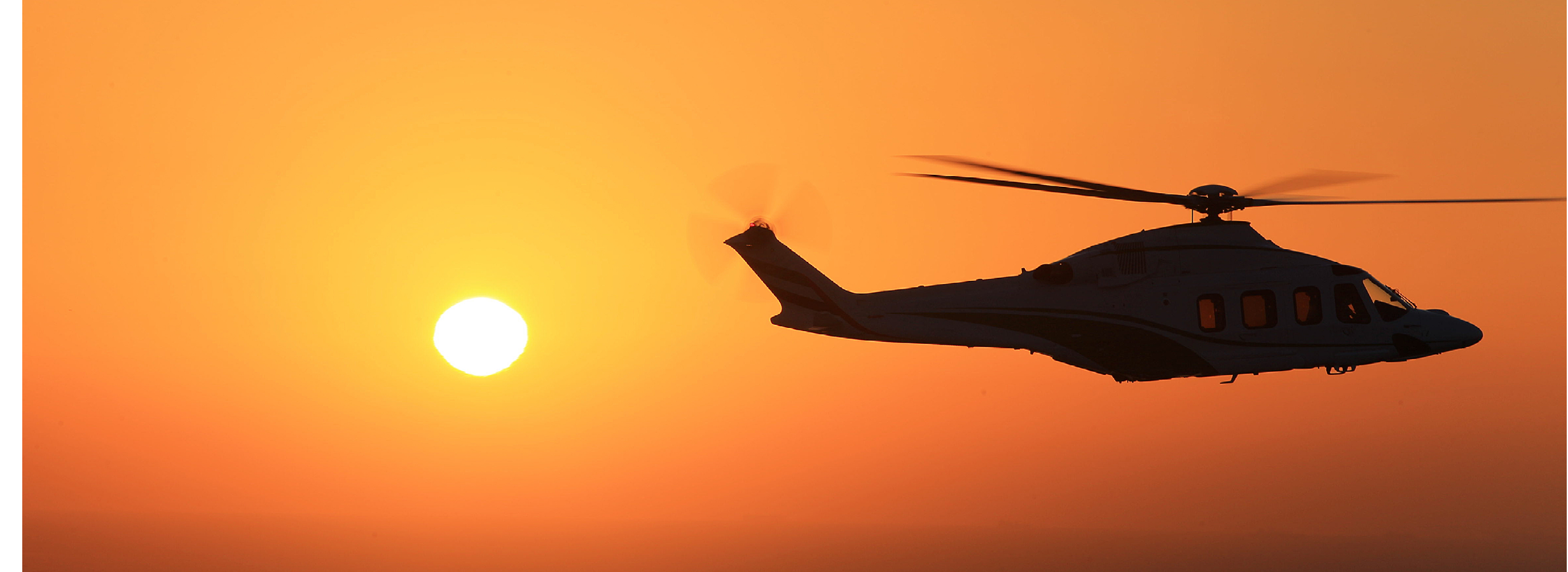 A helicopter flying in the sky. Description generated by AI