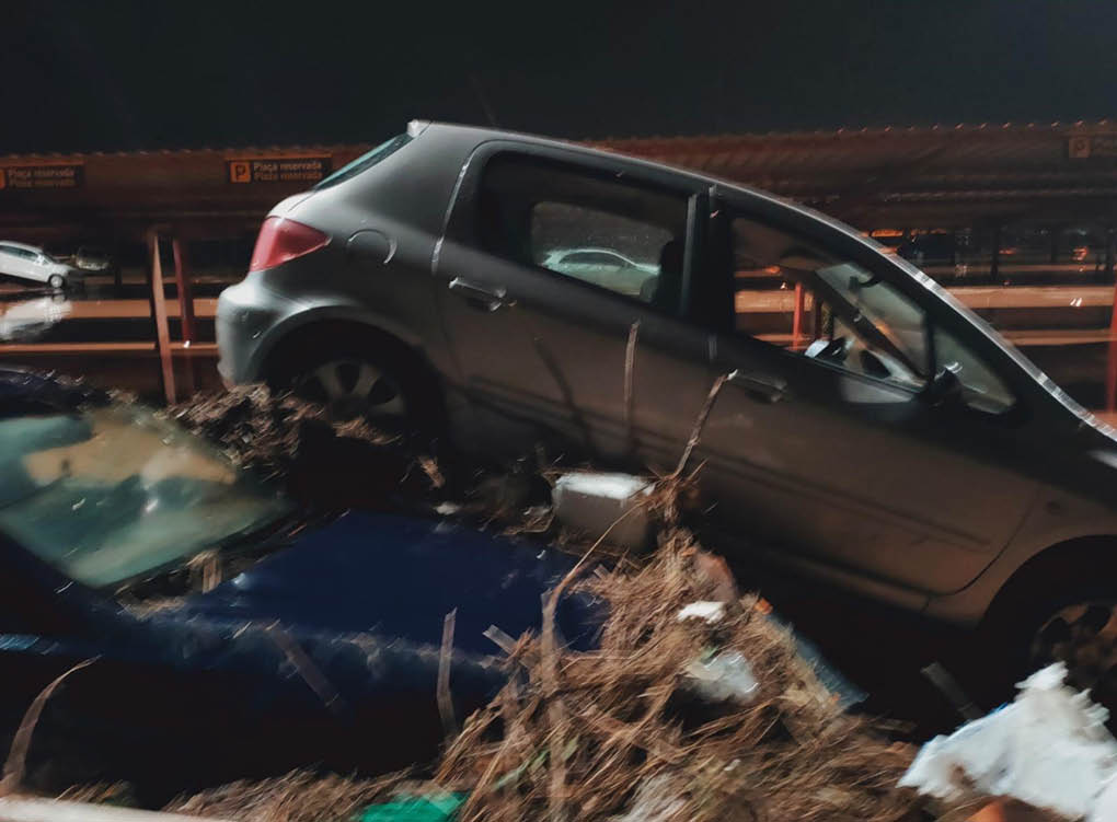 A silver car is on top of a blue car. Description generated by AI