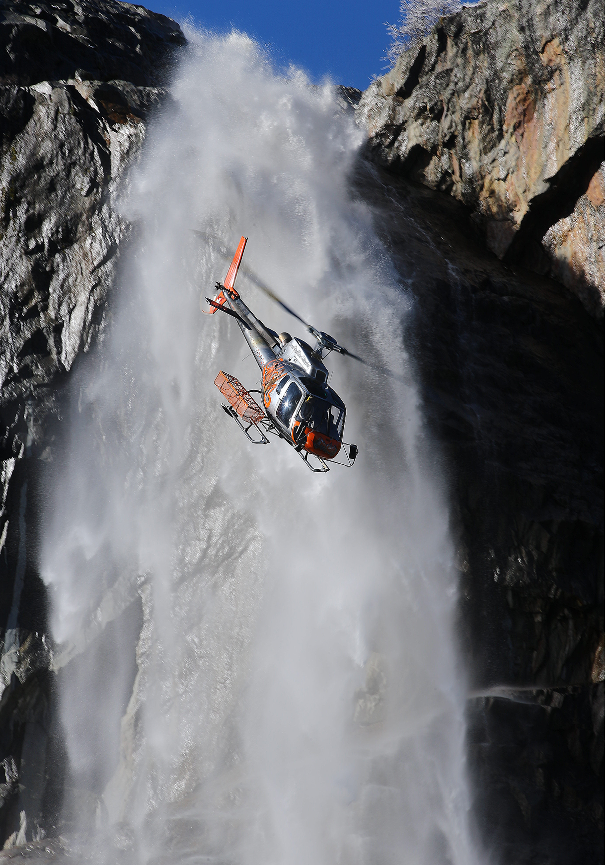 A helicopter is flying through the air and is about to land on a cliff. Description generated by AI