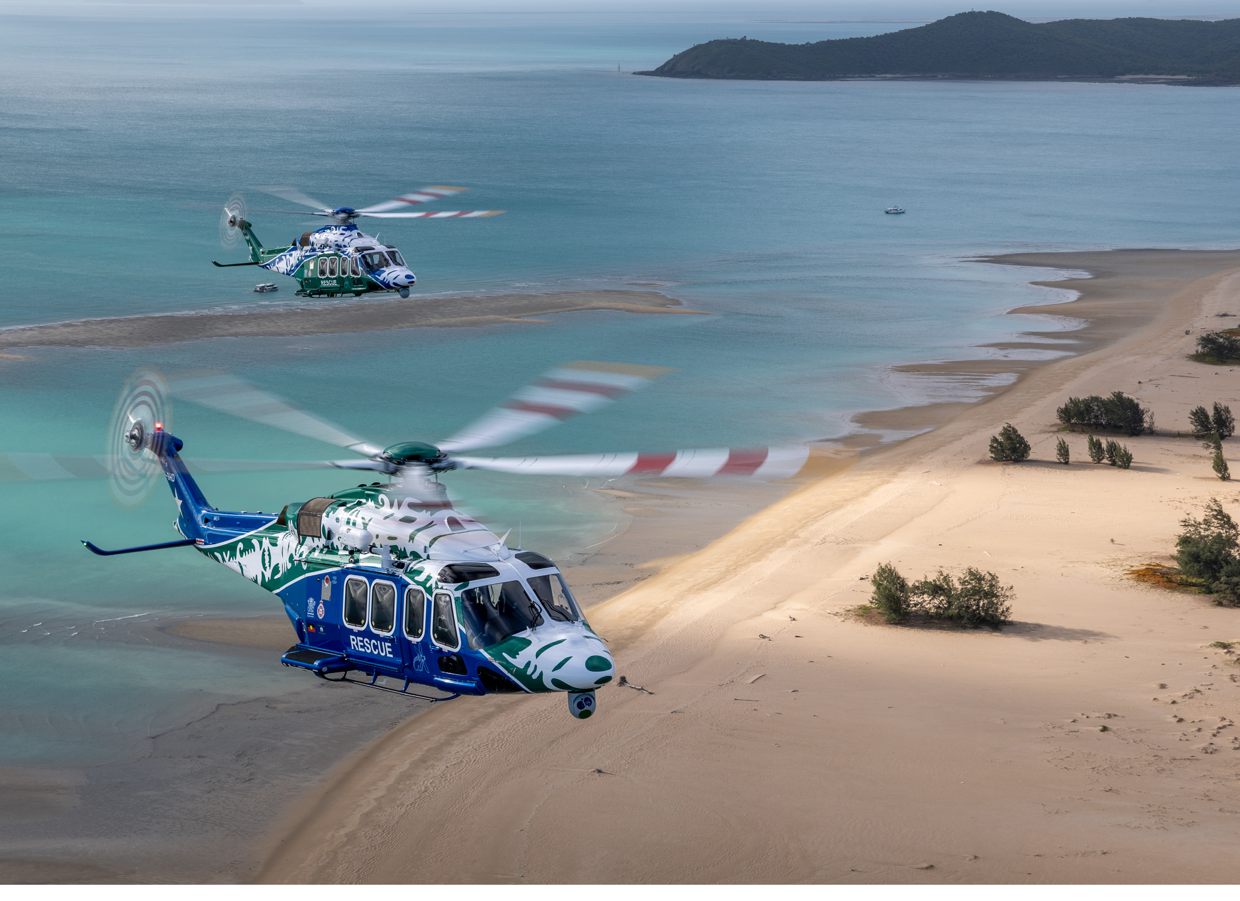 Two helicopters on a beach. Description generated by AI