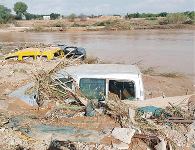 A white truck is submerged in muddy water. Description generated by AI