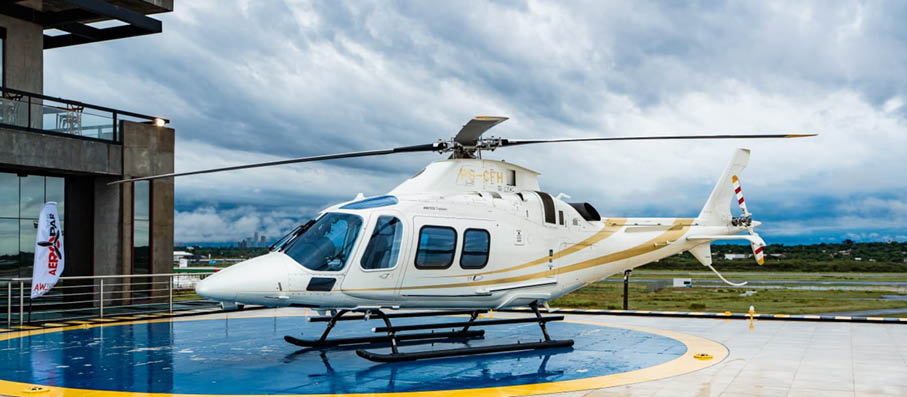 A helicopter is parked on a blue surface. Description generated by AI