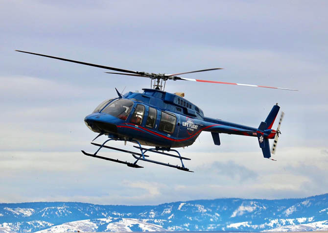 A helicopter flying in the sky. Description generated by AI