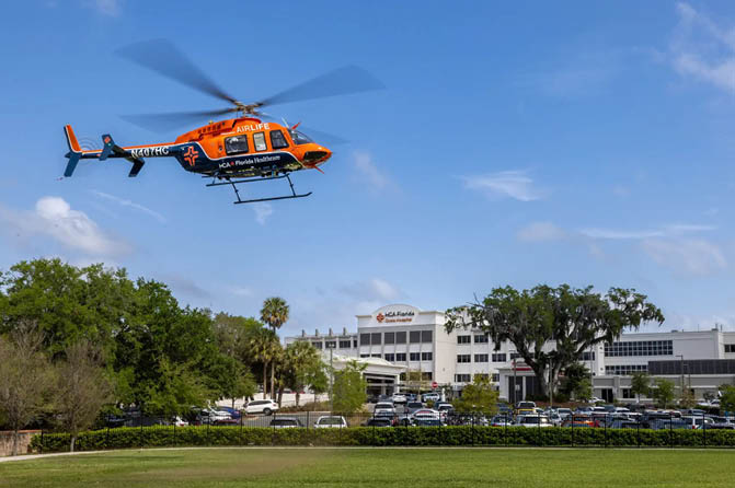A helicopter is flying over a parking lot. Description generated by AI