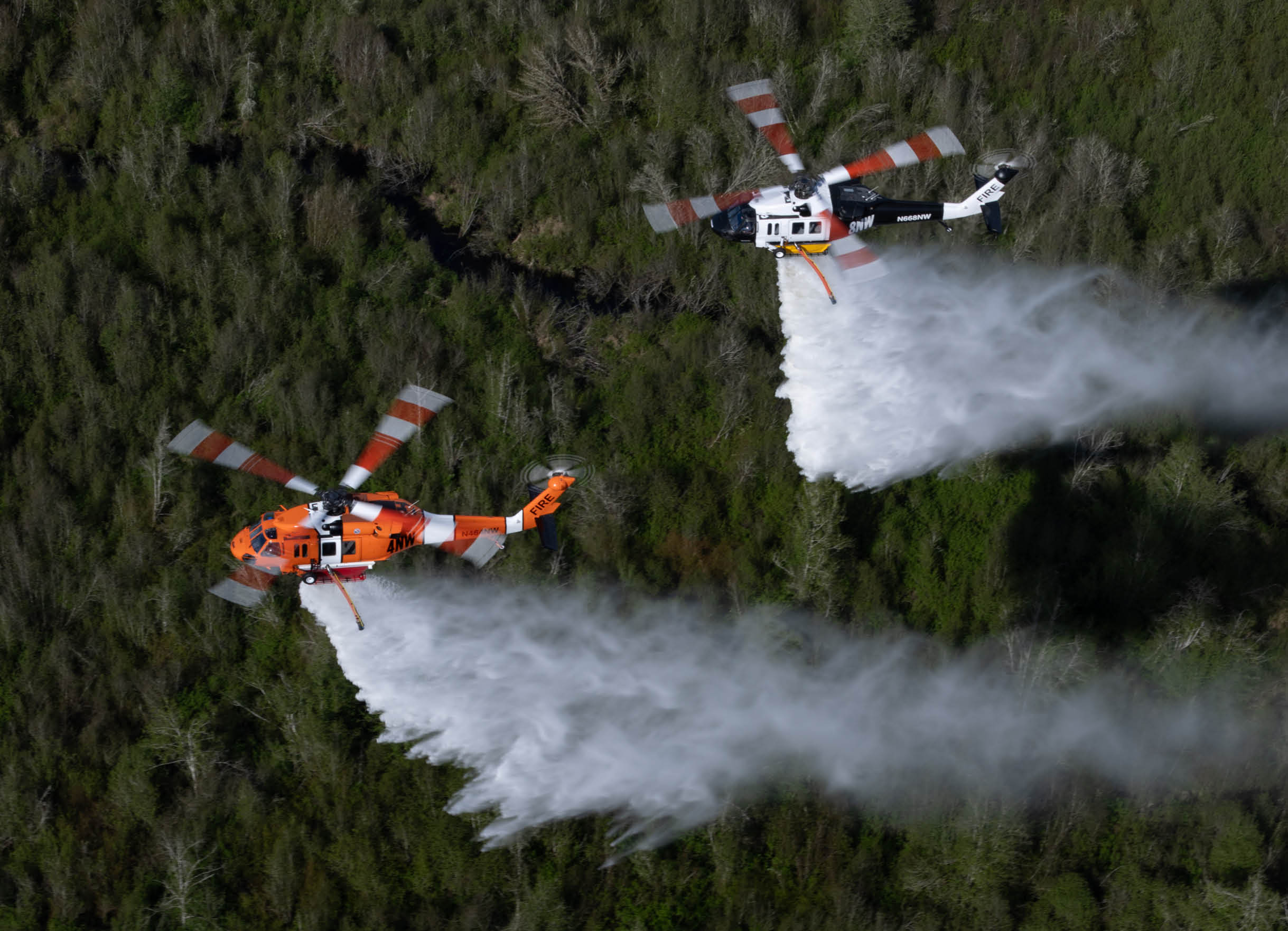Two helicopters are flying through the air. Description generated by AI