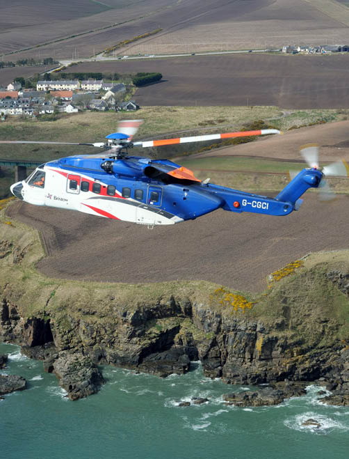 A white helicopter with red and white stripes on the tail. Description generated by AI