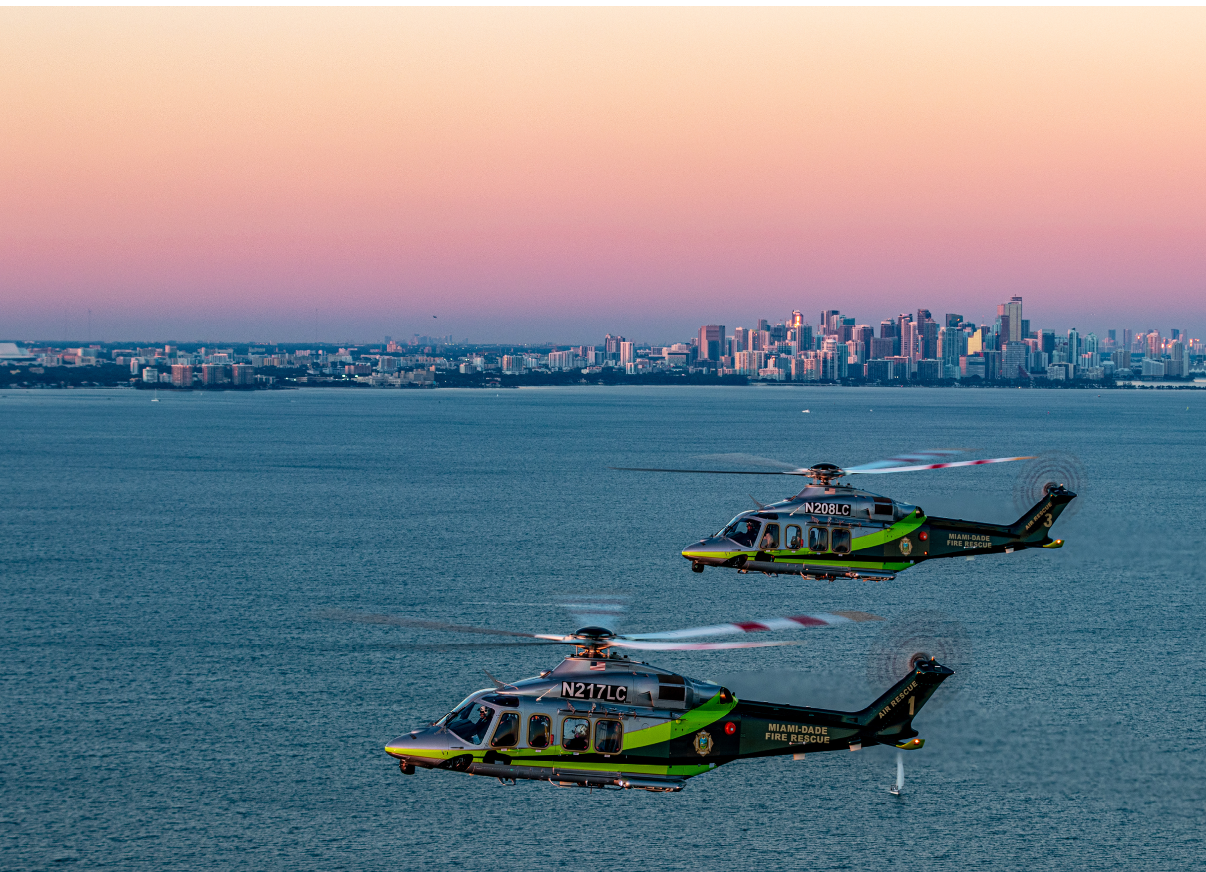 A helicopter flying over a forest during a sunset. Description generated by AI
