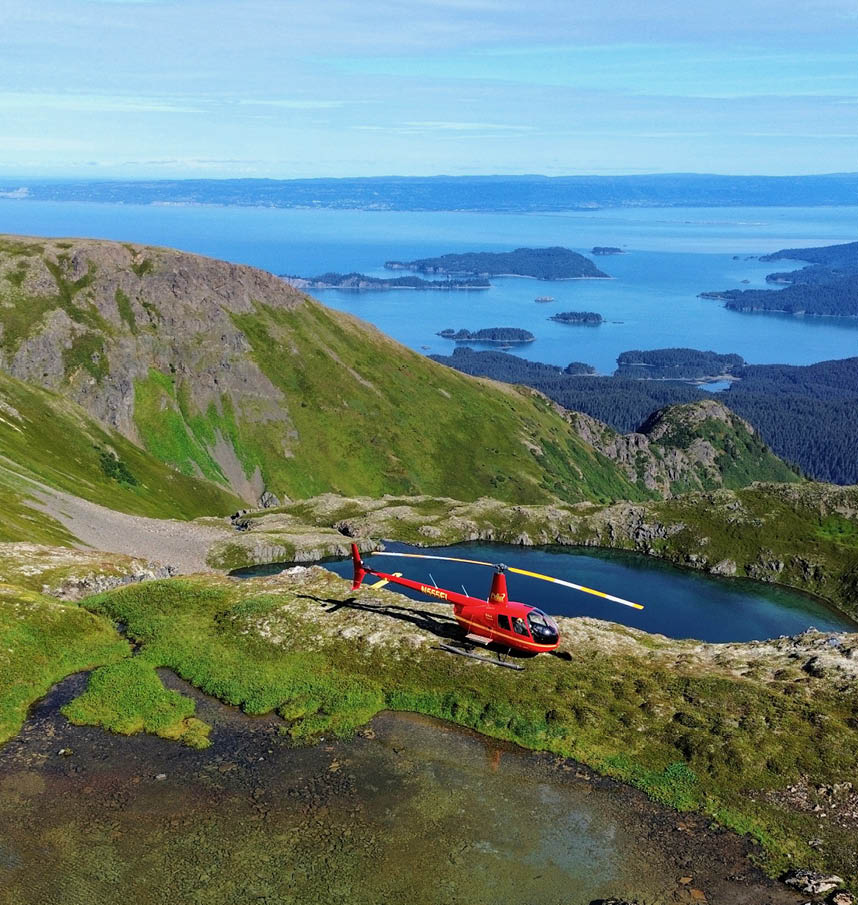 A man standing in front of a helicopter. Description generated by AI