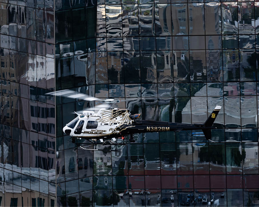 A trophy is on display in front of a helicopter. Description generated by AI