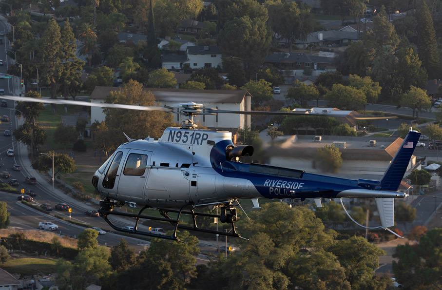 A man in a helicopter is giving a thumbs up. Description generated by AI