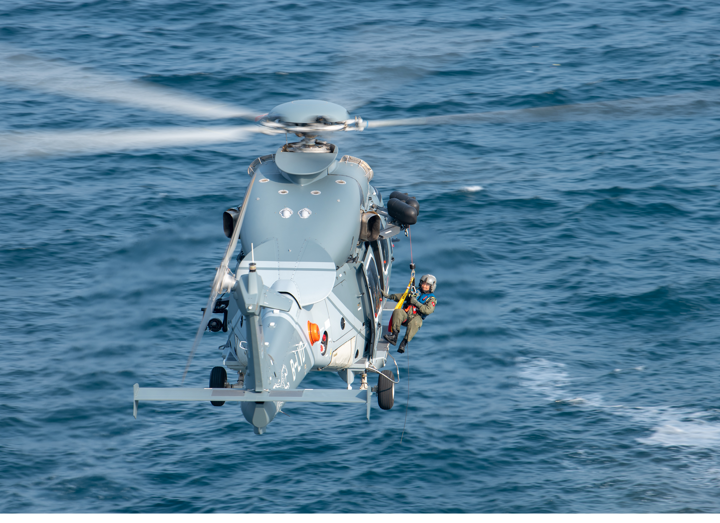 Two helicopters flying in the sky. Description generated by AI