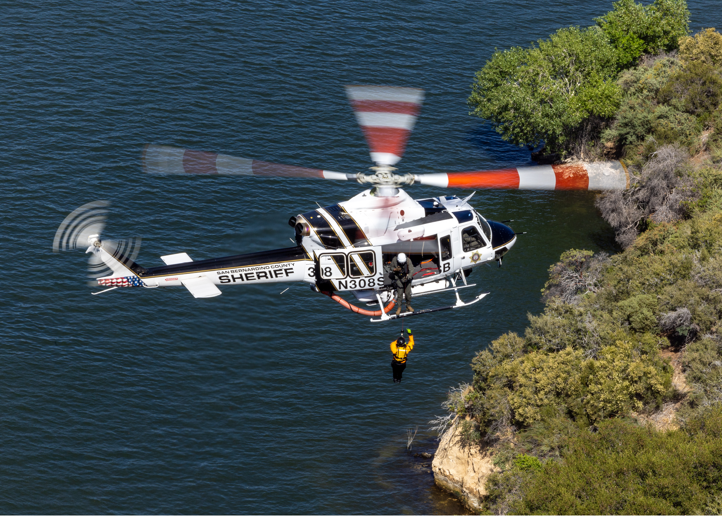 A helicopter is flying over a rock formation. Description generated by AI