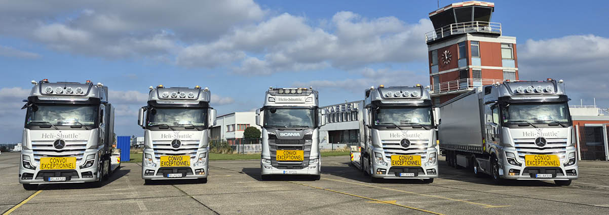 Five trucks are parked in a row on a parking lot. AI generated content