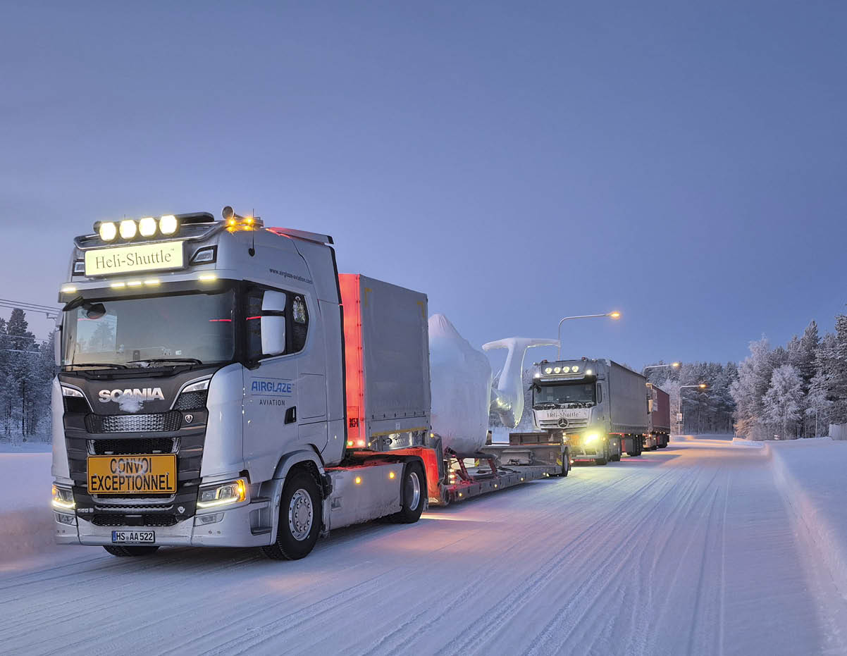 A white semi truck is driving down a snowy road with two other trucks behind it. AI generated content
