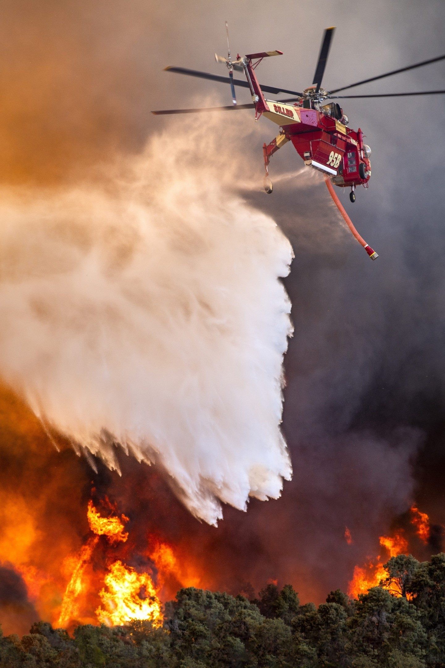 A Siller Helicopter Skycrane drops water at the Sheep Fire near Wrightwood, California. The fire was almost out and what seemed liked
minutes, grew to over 1000 races. I drove on California Highway 2 with intense flames on both sides, following the fire and helicopters.