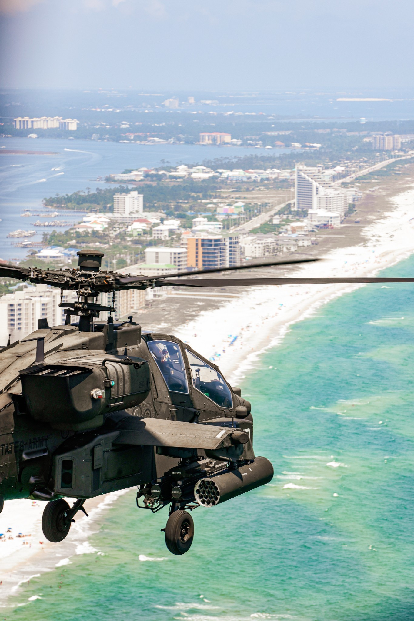 An American AH-64E Apache helicopter out of Fort Novosel, Alabama flies down the Gulf Coast over the Atlantic Ocean. The AH-64 is the
	primary attack helicopter of the United States Army
