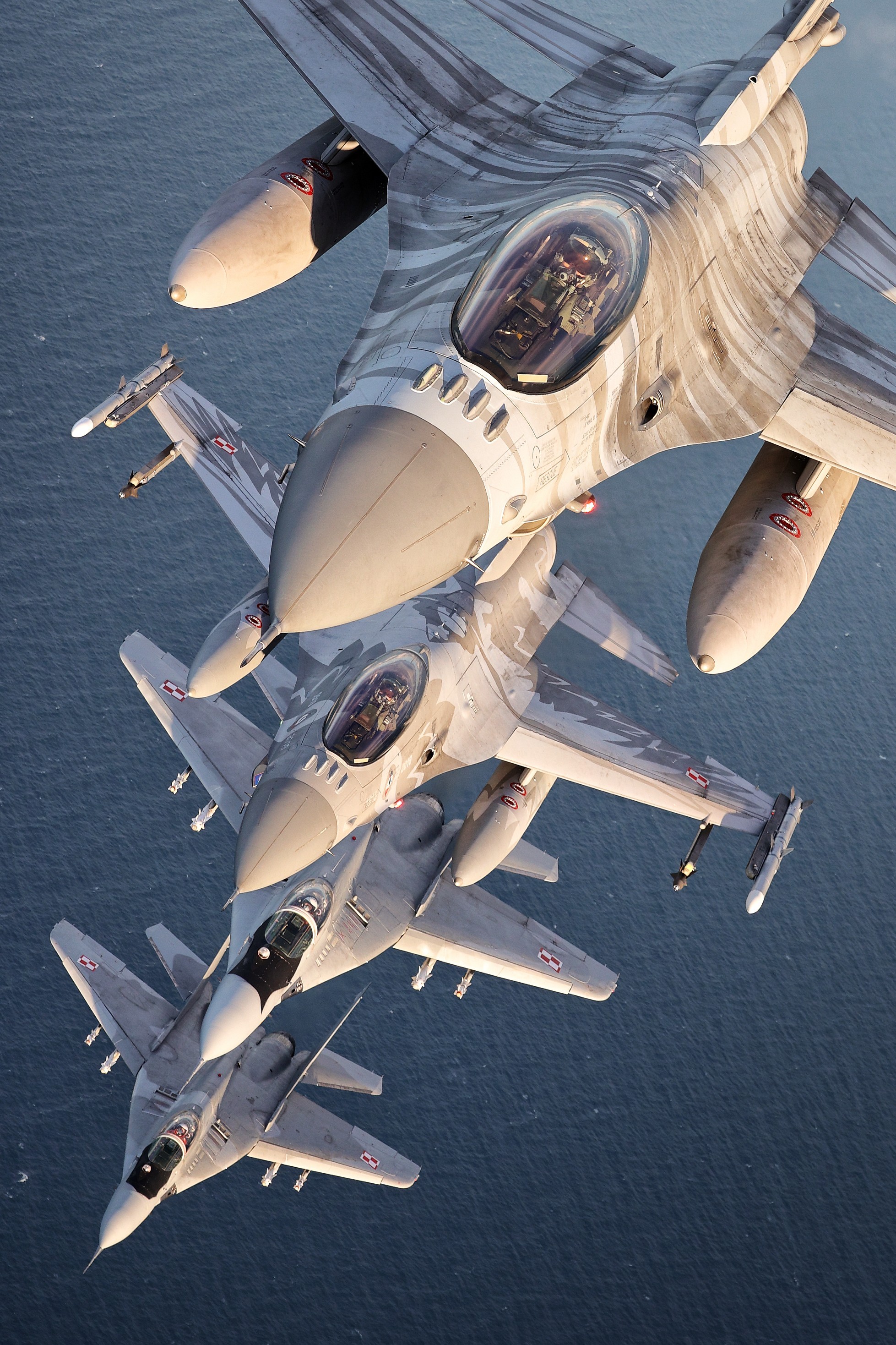 Polish fighter force at its best. Pair of F-16 from 31st Tactical Air Base (note both flag ships - Tiger and Raven jets) accompanied by
MiGs-29s from 22nd Tactical Air Base. Most likely the very last air to air photo shoot of ex-German Fulcrums in Polish service.