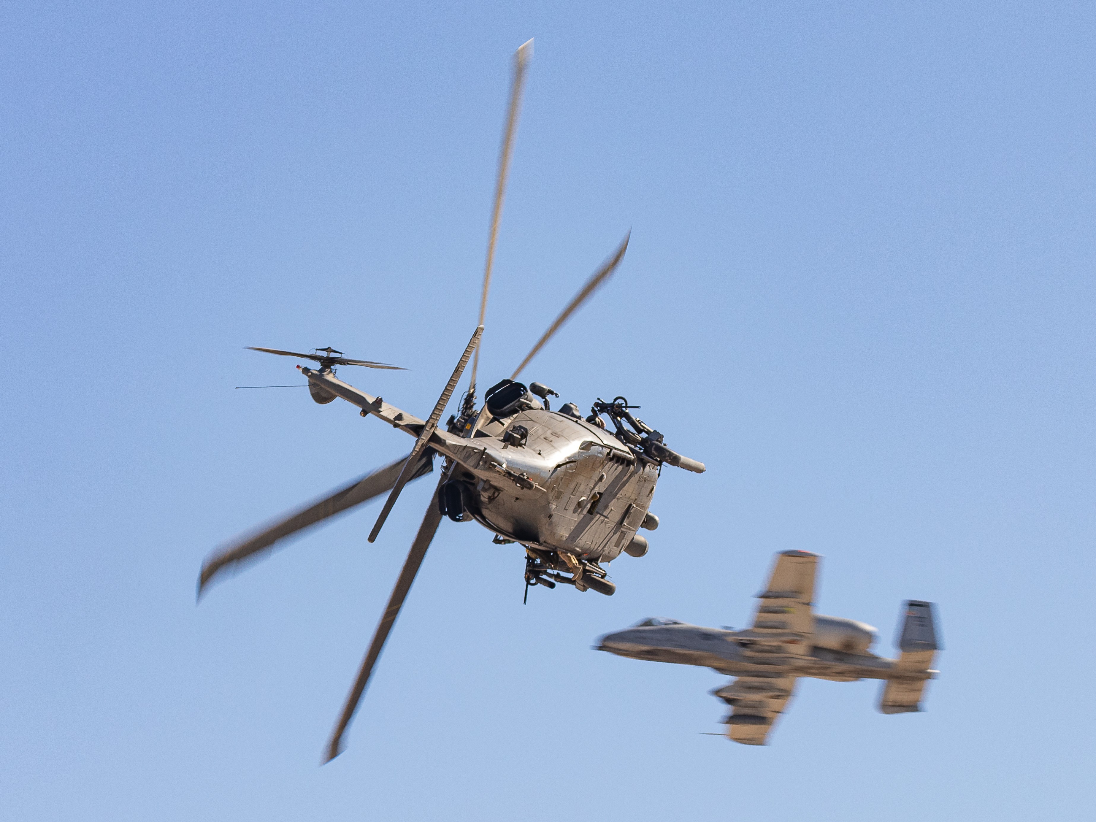 US Air Force A-10C Thunderbolt II providing air cover for a US Air Force HH-60G Pave Hawk helicopter during the combined arms demonstration
at the 2022 Aviation Nation Airshow at Nellis AFB, Nevada, USA