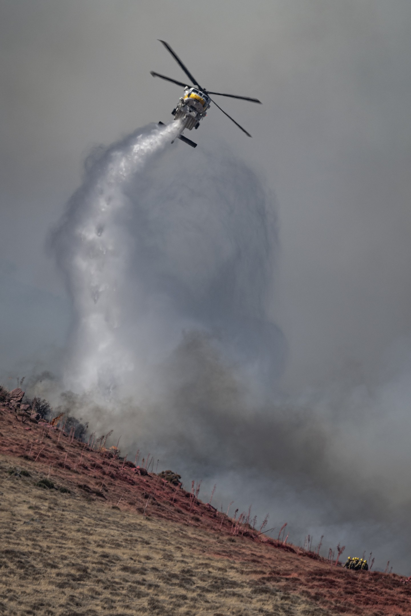 Los Angeles County Fire Copter 22, fighting the Hawk Incident in Acton, California. The aircraft and hand crews were trying to keep the flames from crossing a ridgeline on the hillside. The helicopter made amazing turns while dropping water to put the water exactly where it was needed.