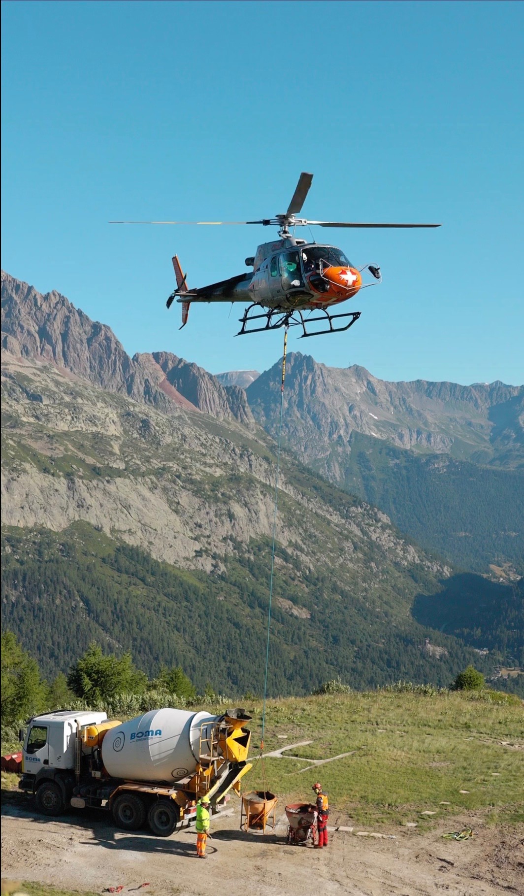 Concrete reload at the Grands Montets construction site. 
Helicopter rotation supplying material directly to the mountain work zone