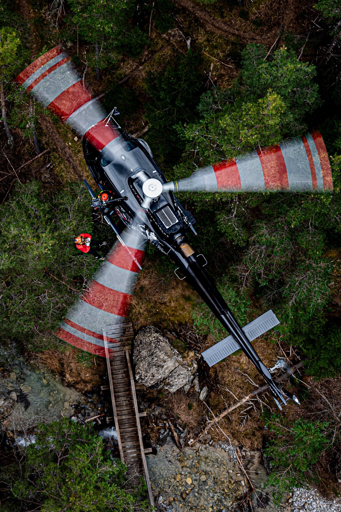 I captured this rather incredible image during an air-to-air shoot with Savoie Hélicoptères during a helicopter hoisting operation. The hoisting was approximately 35 meters below the H125 to reach the wooden walkway.