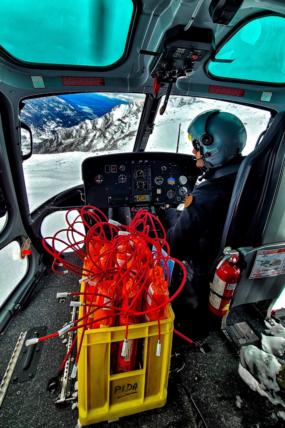 I captured this extreme and rare moment of a basket of dynamite in an H125 to trigger avalanches in the French Alps. I was a helper in the helicopter at the time, which is why I was able to capture this photo since safety is very controlled with this type of explosives.
