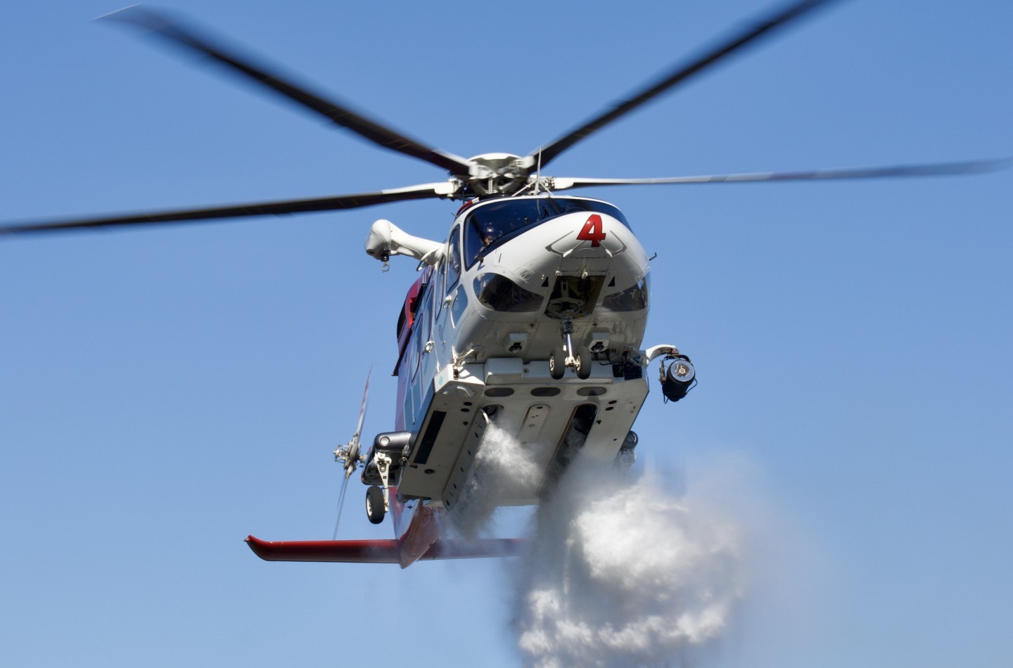 Los Angeles Fire Department (LAFD) "Fire 4" making a water drop on a small vegetation fire adjacent to the highway.