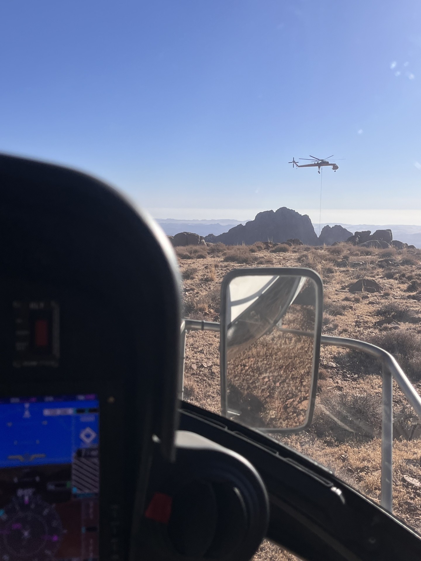 H125 supporting S64F Skycrane in mountain external load ops.