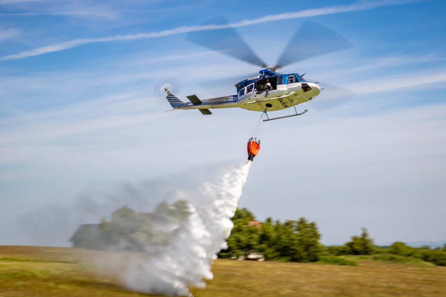 A Czech Police Bell 412 dropping water at a training exercise with Czech and German firefighters.