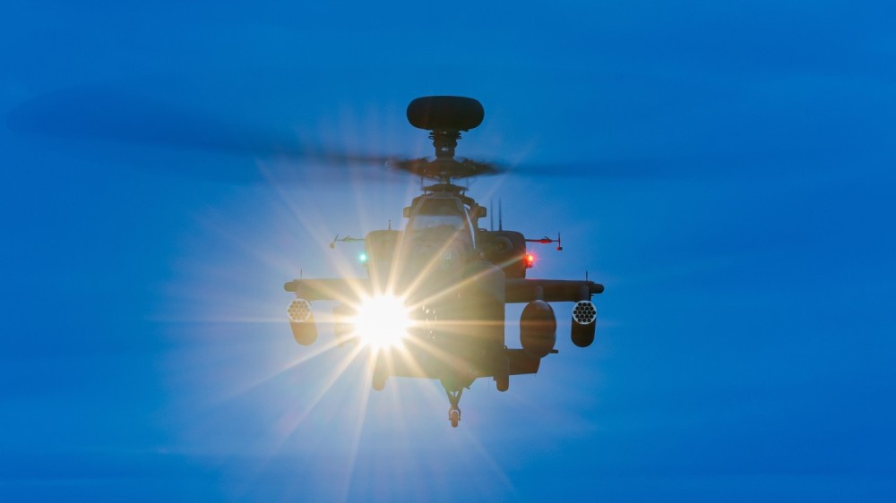 Eye-to-eye with a Boeing AH-64 Apache attack helicopter of the British Army Air Corps during a night mission at RAF Odiham.