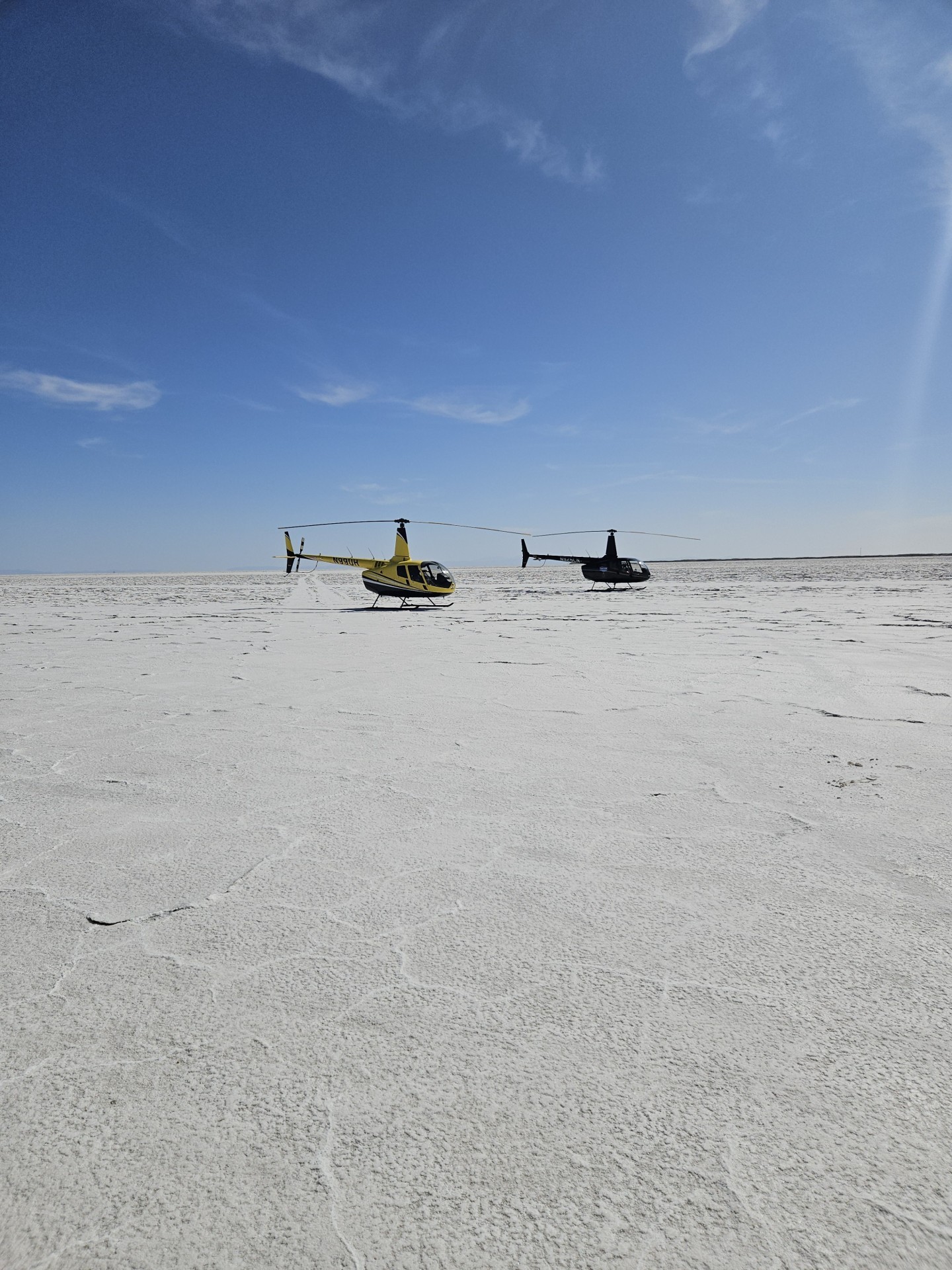This was on the Bonneville Salt Flats in Utah. 2 R66 Helicopters being showcased to a variety of people. The salt flats speak for themselves and makes it look like the helicopters are on water and waves.