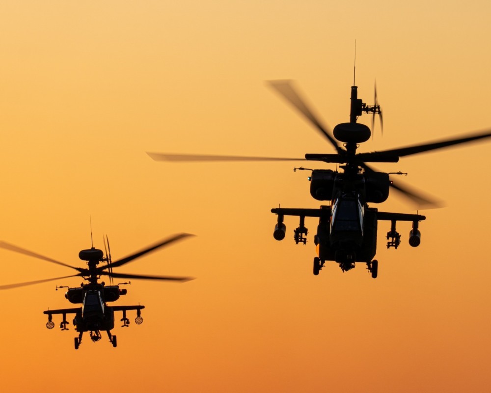 Here you see two Dutch AH64E Apaches taking off together at sunset, straight towards me. A classic case of: right time, right place. I'm very happy with this photo because they look great together, and the last sunlight casts a beautiful orange glow.