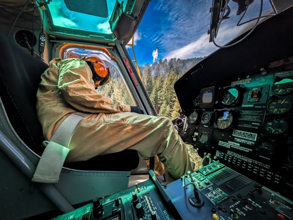 Inserting rappellers into a fire while a Blackhawk conducts drops in the background.