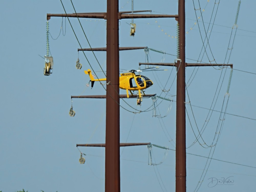 Winco Powerline Services MD500 series helicopter stringing pilot rope on the CAPX2020 transmission power line upgrade project in Dakota County, Minnesota.