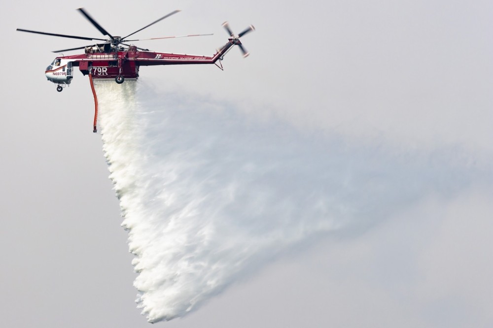 Helicopter Transport Services Sikorsky S-64 Skycrane N6979R making a drop on the Allen Creek Fire near Peshastin Washington after drafting from the nearby Wenatchee River.