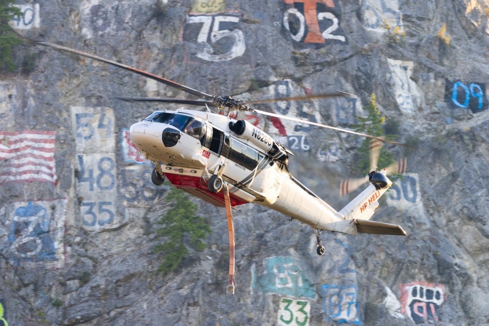 HP Helicopters Sikorsky Blackhawk N8286 descending the Entiat River valley in front of Numeral Mountain about to draft water from the Columbia River in support of the Lower Sugarloaf Fire