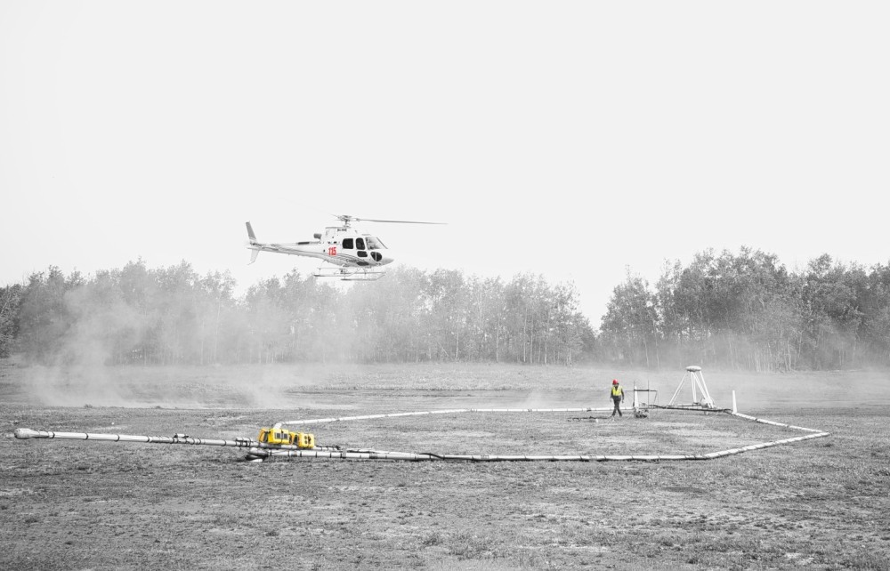 An AS350 B3 helicopter with Heli-worx Aviation doing airborne geophysical surveys in Saskatchewan