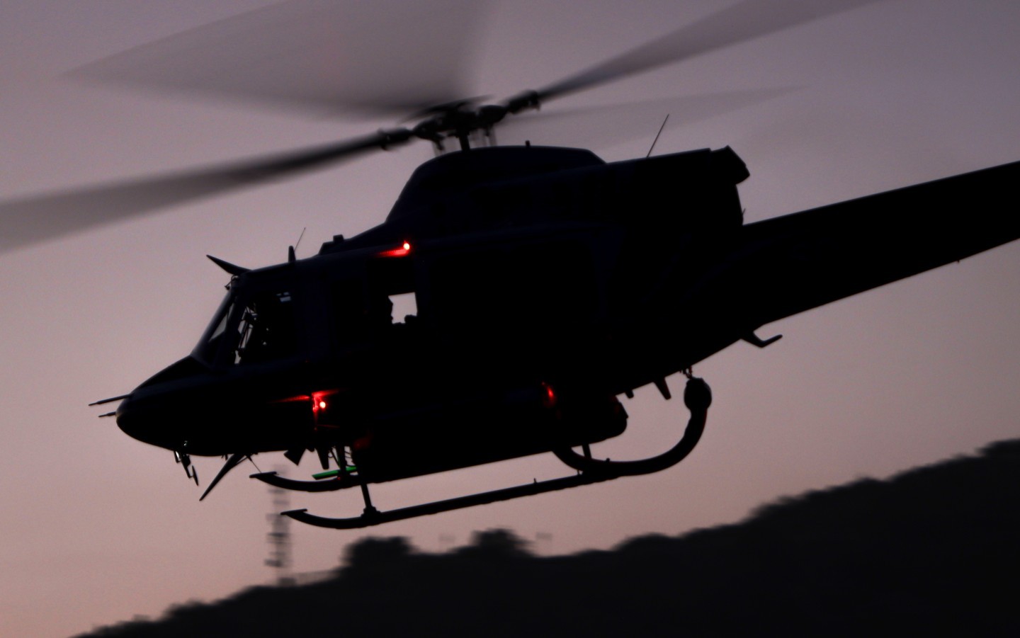 San Diego County Sheriff Department's Copter 11, departs Pala, CA right after sunset after battling the Henderson Fire that started in the late afternoon hours on a Friday in May 2025.