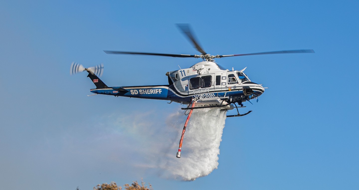 San Diego County Sheriff's Department Copter 11 on a drop during the Coaches fire. Copter 11 made numerous drops on this fire.