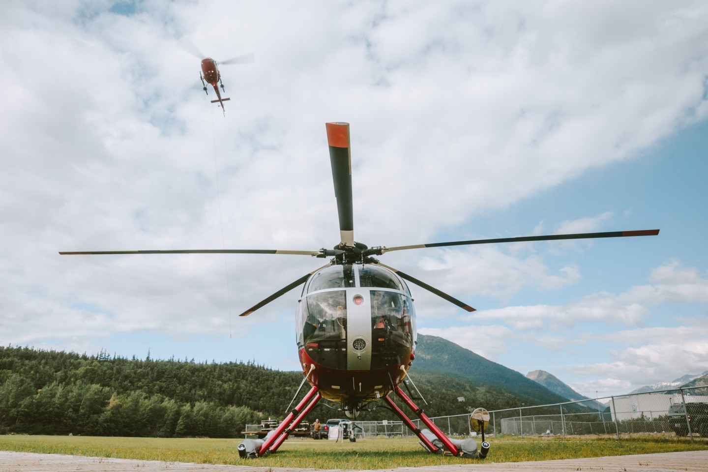 Our MD500D waits paitently to fly while one of the Astars is working a sling job in the background.