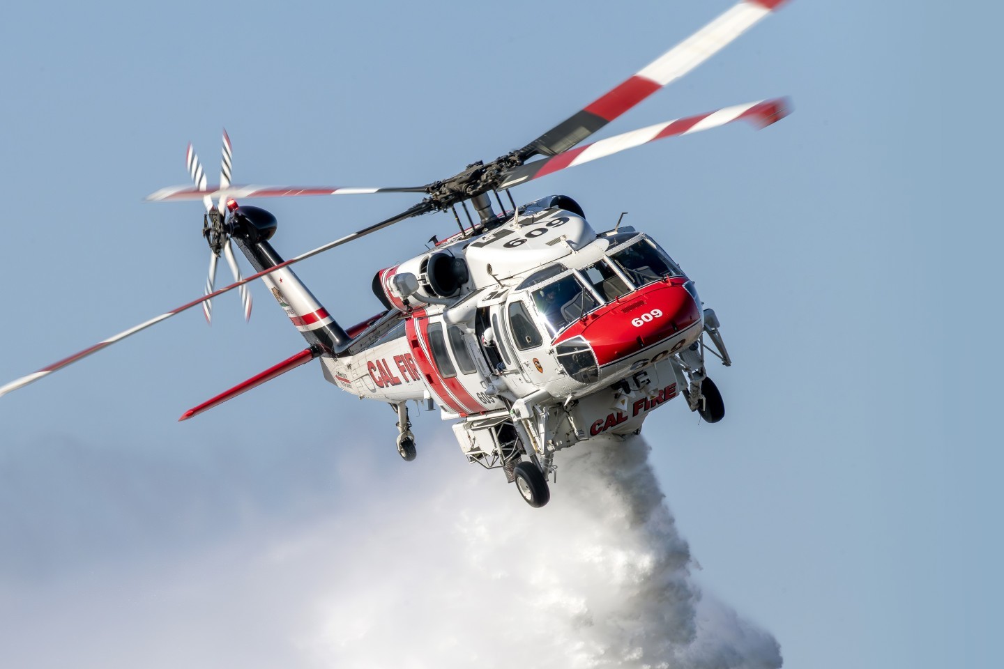 After hiking into a hilly open field, I photographed Cal Fire's Firehawk dropping on the Baxter Fire in Murrieta, California. The lighting and angle were beautiful, which worked well for this close up photograph.