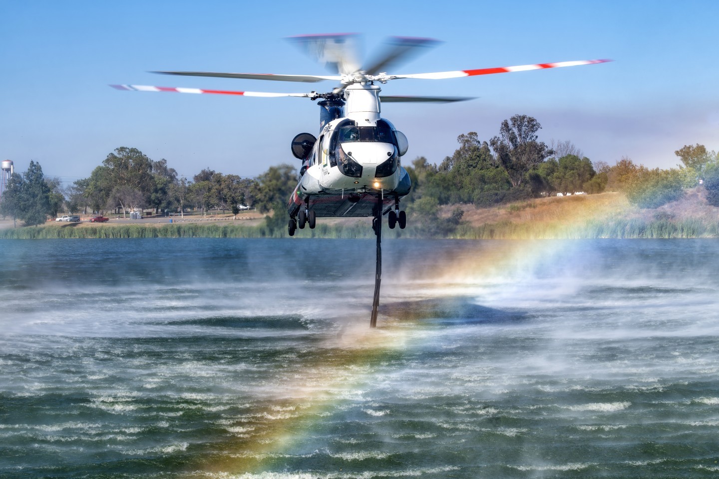 Coulson's Orange County Fire Authority Chinook picks up water at Prado Regional Park to drop at the Euclid Fire in Chino Hills, California. By shooting as low to the ground as possible (avoiding vegetation in the foreground), I was able to capture the rainbow in the frame.