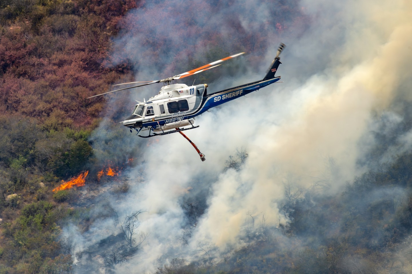San Diego County Sherriff’s Bell 412 helicopter heads back to pick up water for the Henderson Fire in Pala, California. It was quite difficult to get to this mountain location where we were above, or at eye level, as various aircraft dropped.  We had to go on private land and fortunately the owner gave us permission, and actually drove us to a better location in an all-terrain vehicle. Being able to photograph these highly skilled and brave pilots is such an honor and privilege.