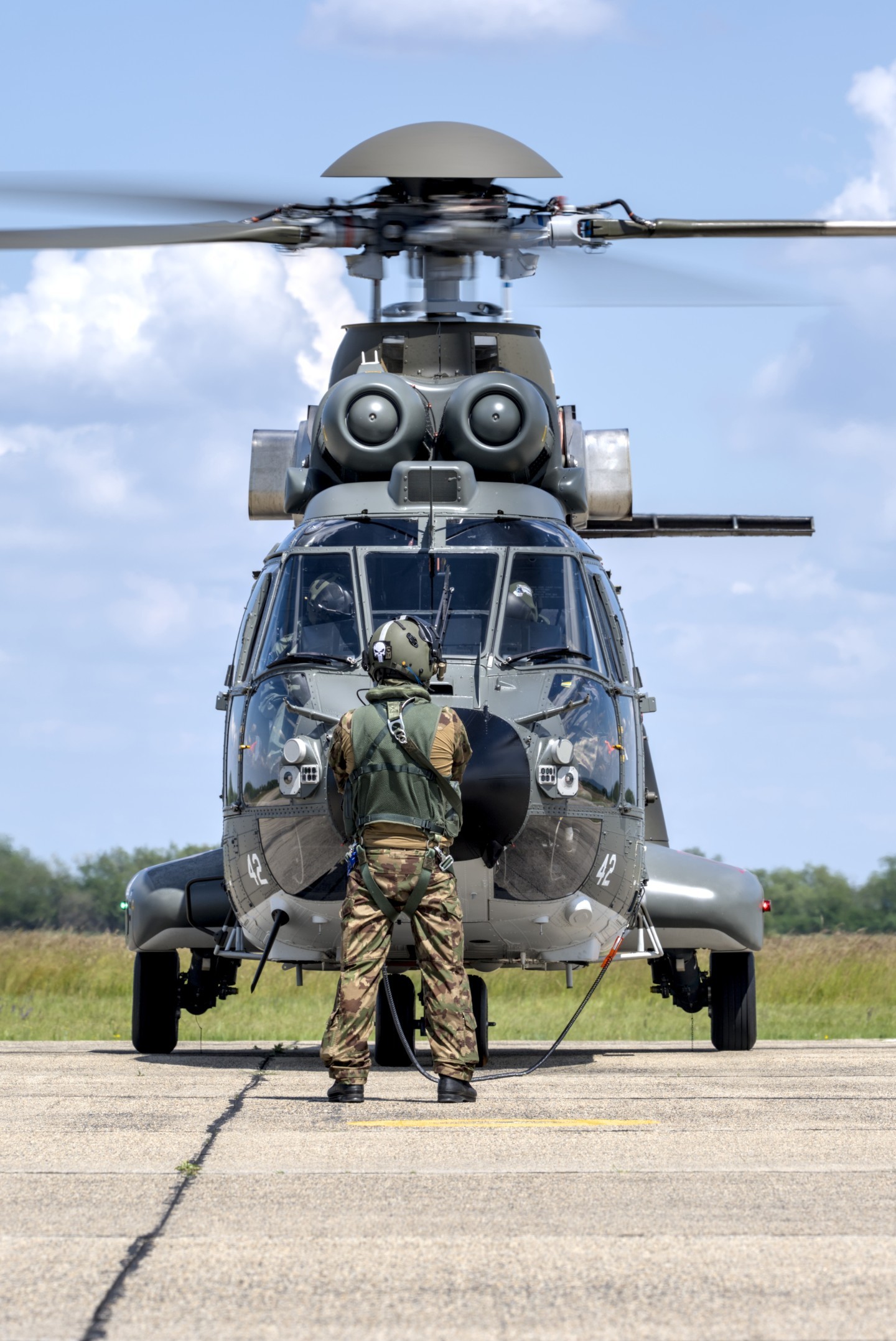 20250527 Swiss Cougar helicopter at Papa AB during the MHTC helicopter exercise FireBlade prior to take off. The loadmaster checks the helicopter before take off
