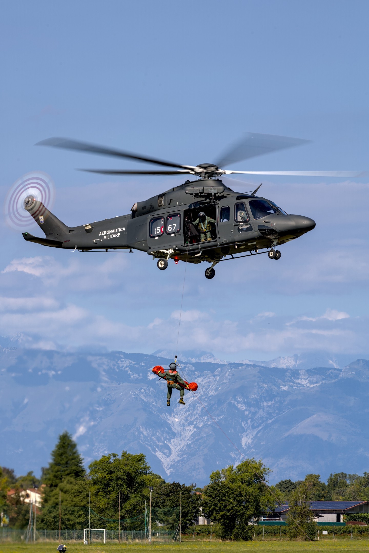 20250906 During the 2025 Rivolto irshow, this Italian Air Force SAR helicopter gave a SAR demo against a stunning backgound of the Alpine mountains